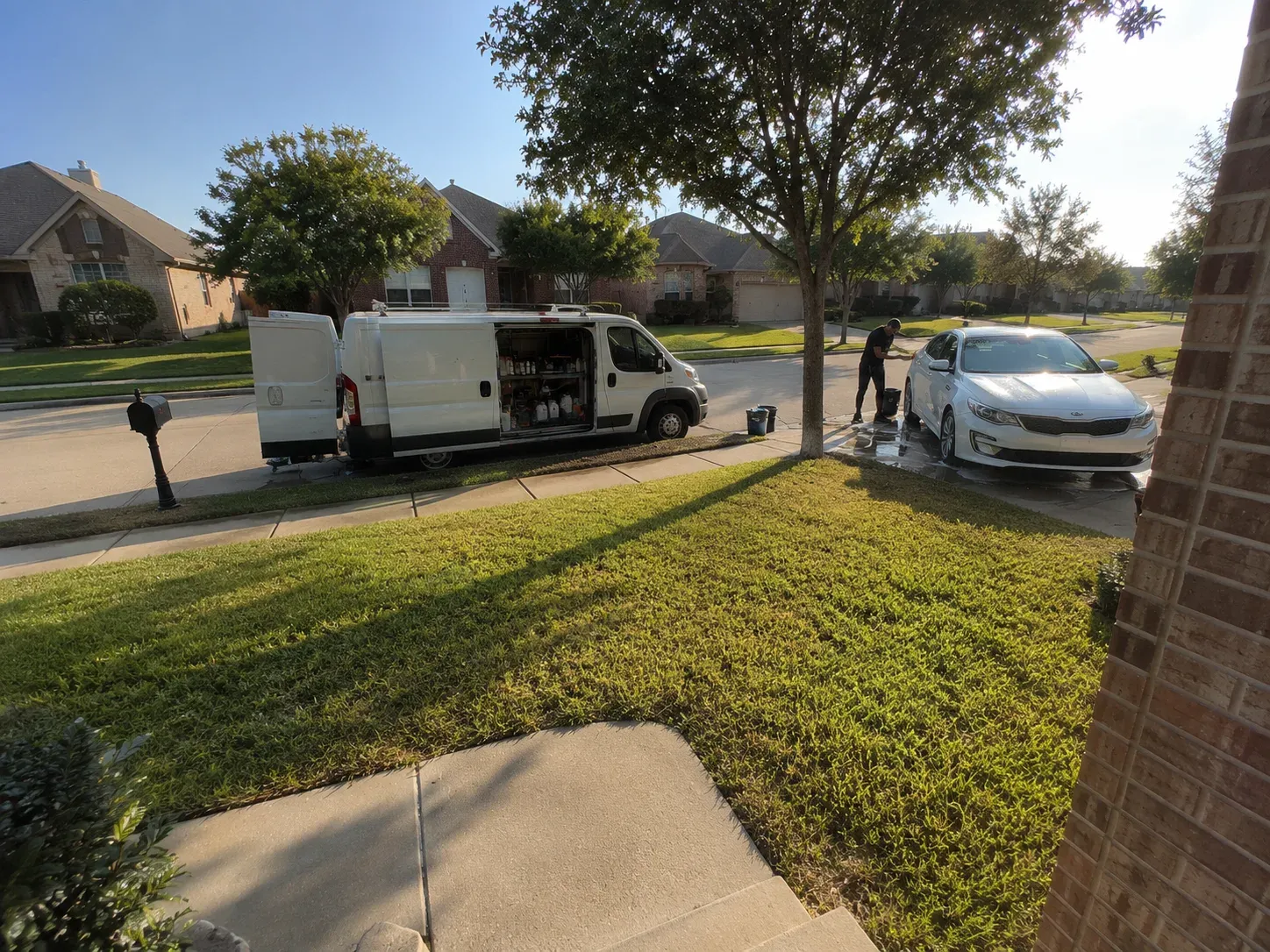 Homeowner view of mobile clay bar treatment van in Fort Worth driveway