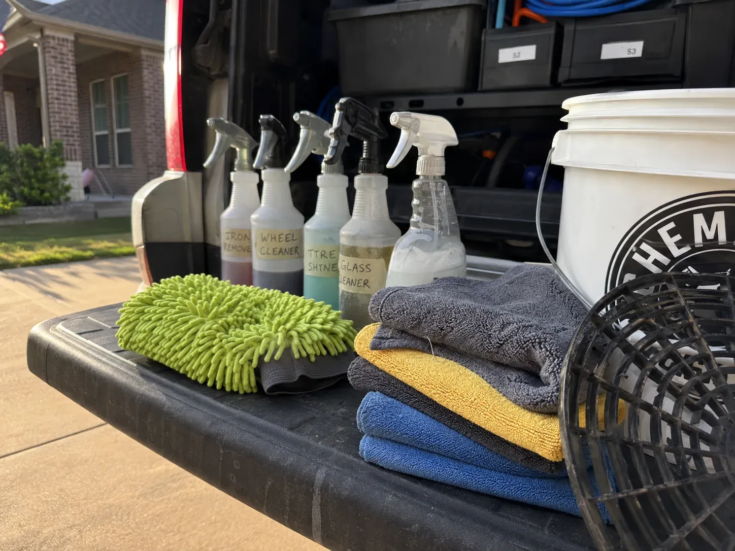 Auto detailing tools and supplies laid out on a van tailgate in Fort Worth