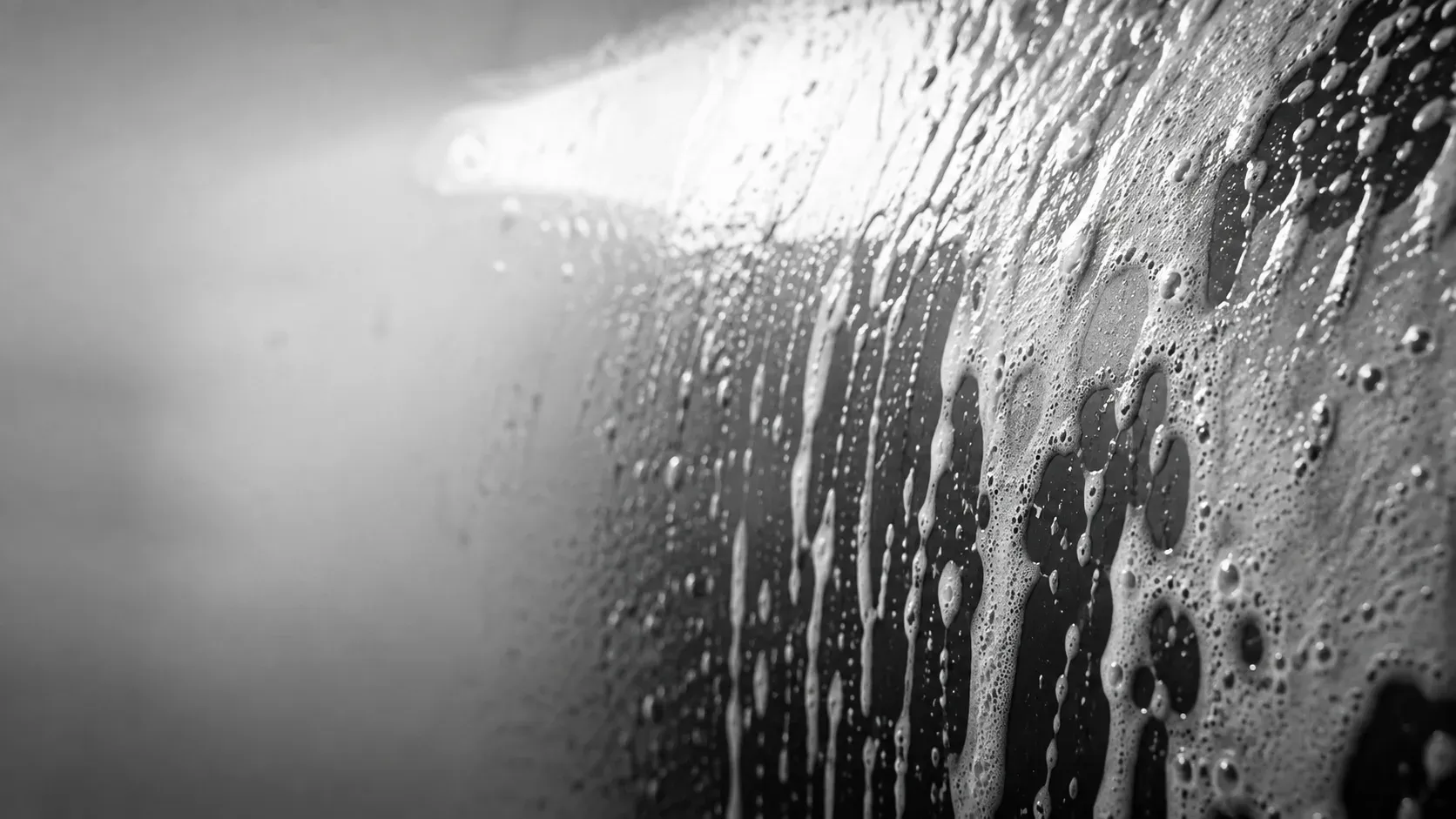 Soap suds running down clean car paint