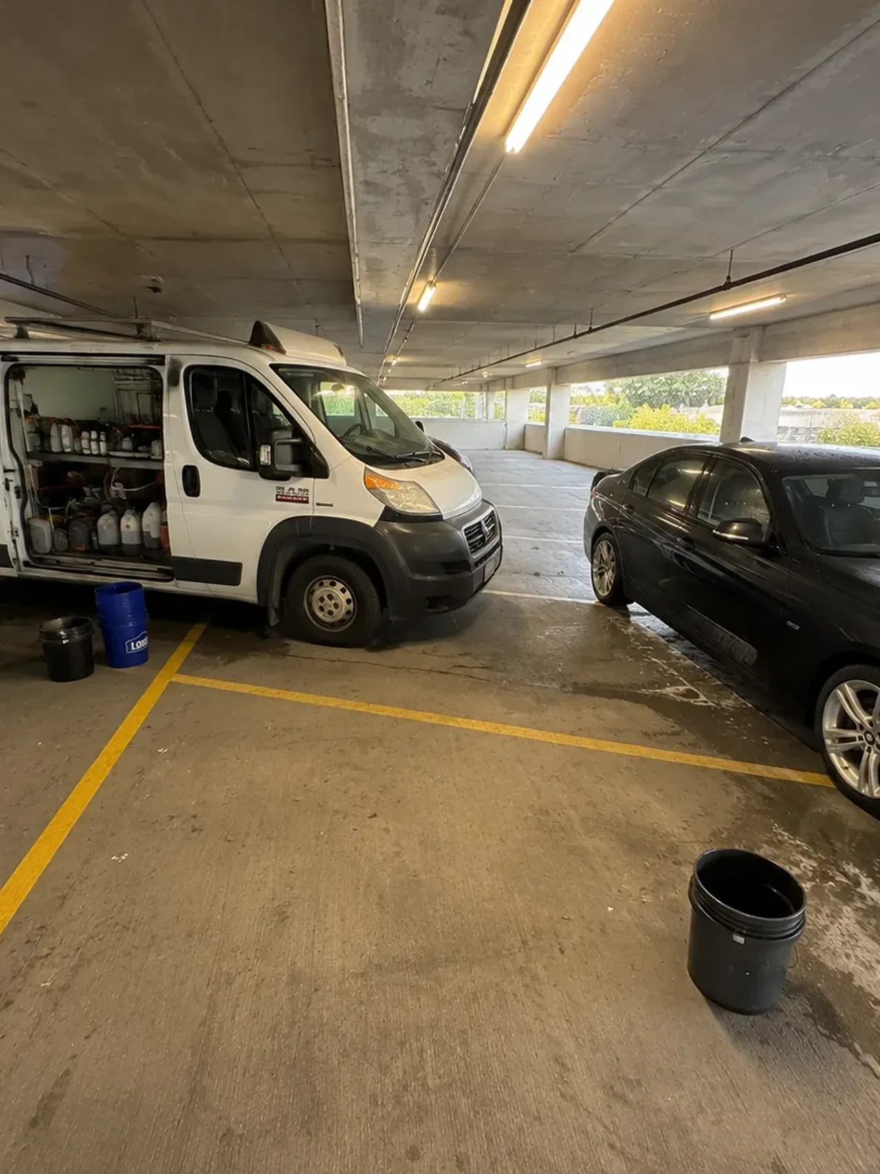 Detailing supplies beside a car in an Irving parking garage