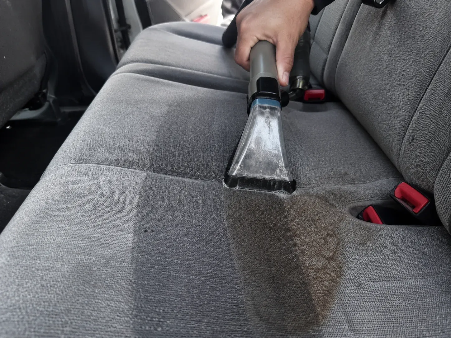 Shampooing a stained cloth car seat in Irving